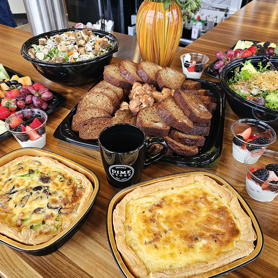 Dime Store catering spread with house-made banana bread, quiche, fruit trays, salads & yogurt parfaits