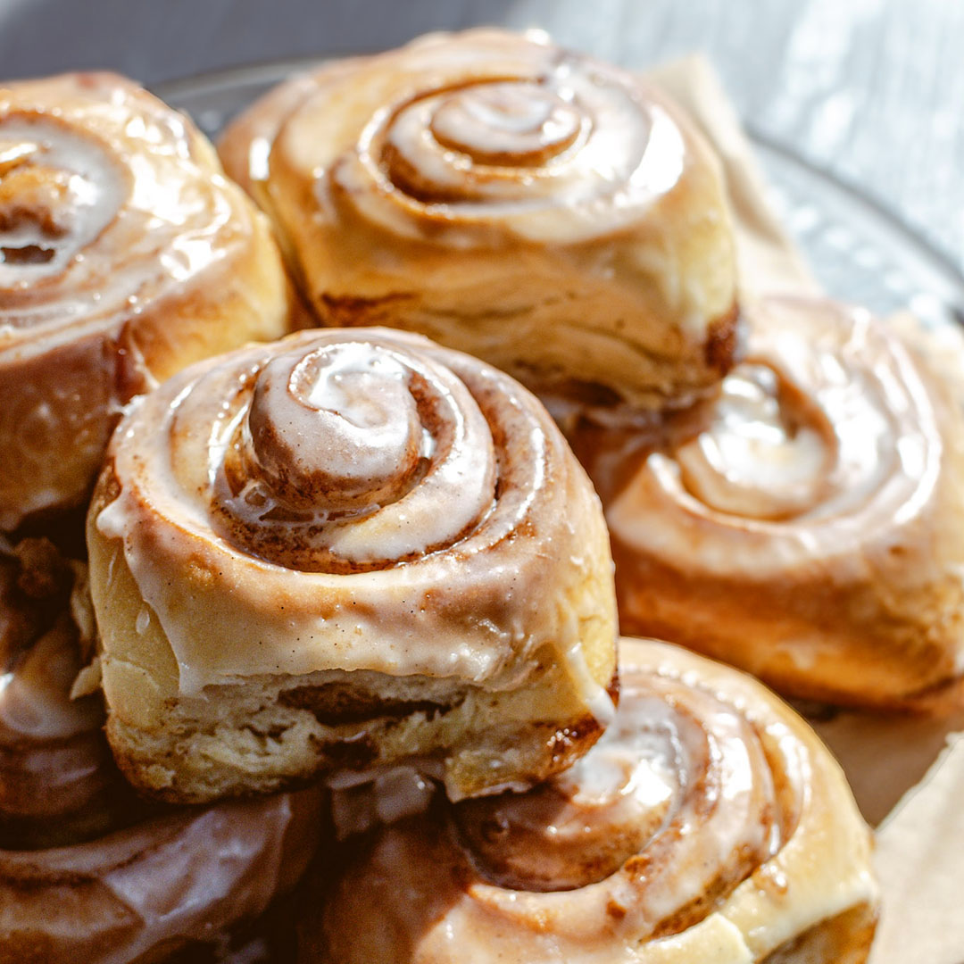 A plate of fresh-baked cinnamon rolls, a Dime Store Rochester Hills-exclusive item from Chef-Owner George's personal recipe book