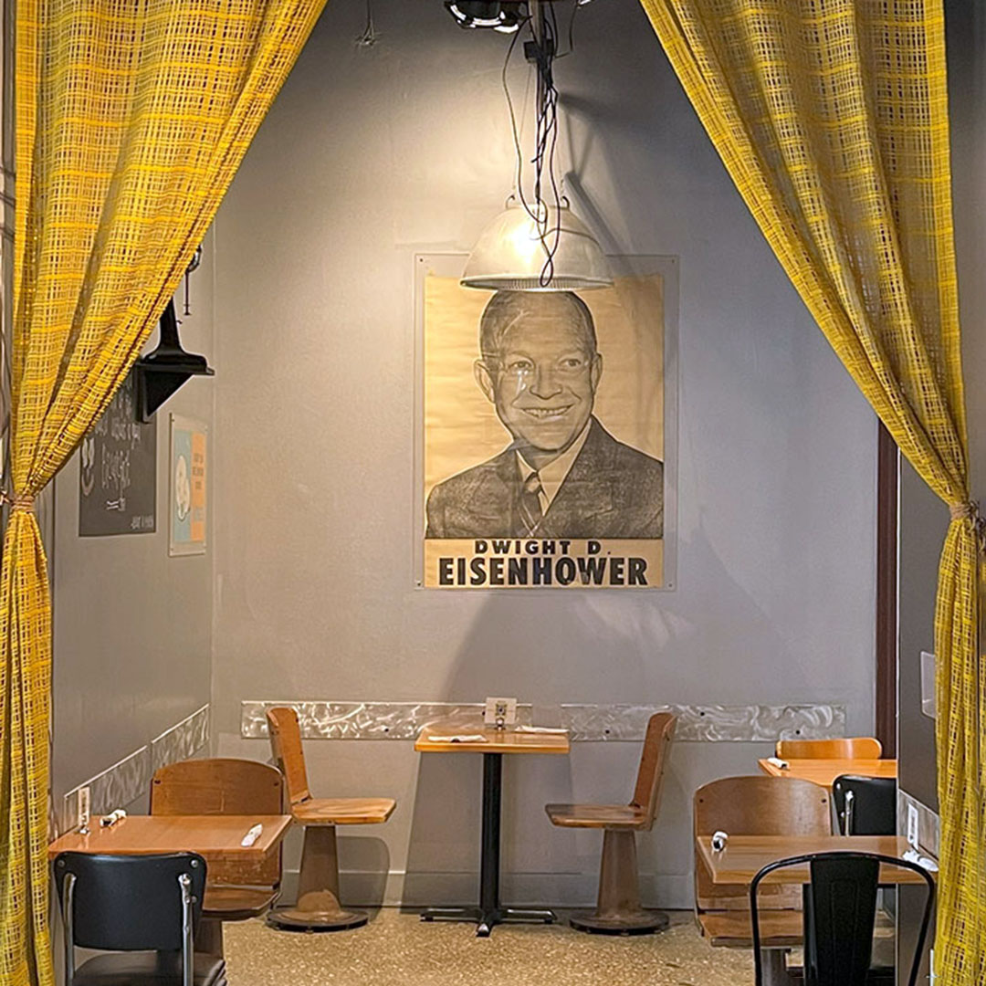 Vintage Eisenhower poster hanging inside Dime Store Detroit’s dining area