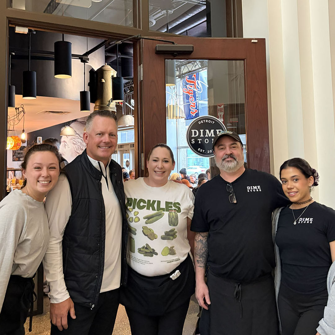 AJ Hinch with Dime Store Detroit staff inside downtown Detroit brunch restaurant